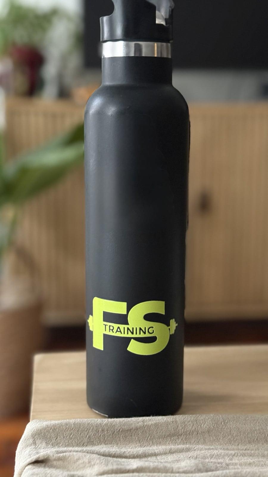 Sticker con el logo de FS Training aplicado sobre una botella